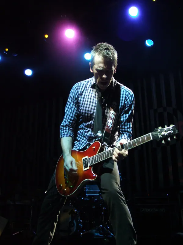 Tommy on stage under colored lights